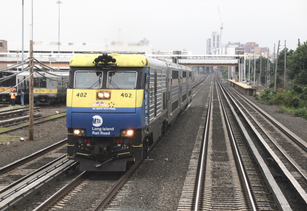 Blue and yellow diesel pulling commuter train