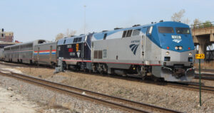 Amtrak train with dark blue engine as second locomotive