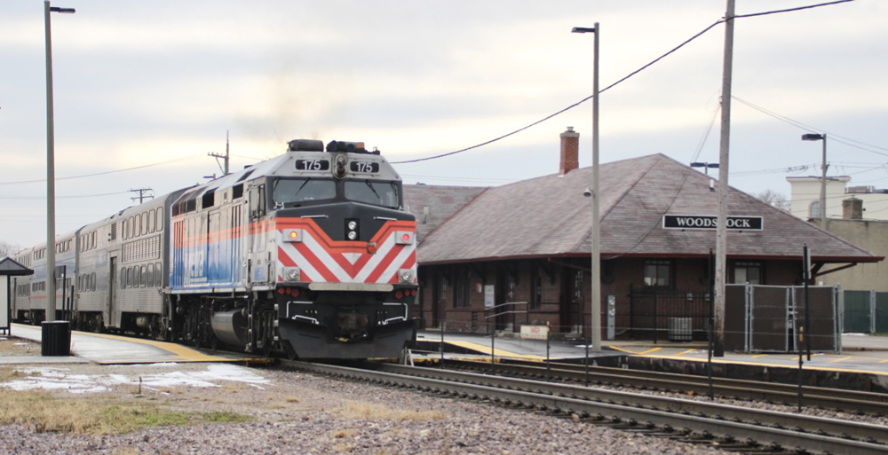 Commuter train passes station