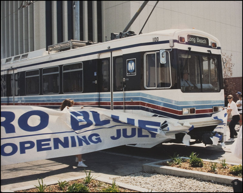 Light rail train breaking through banner