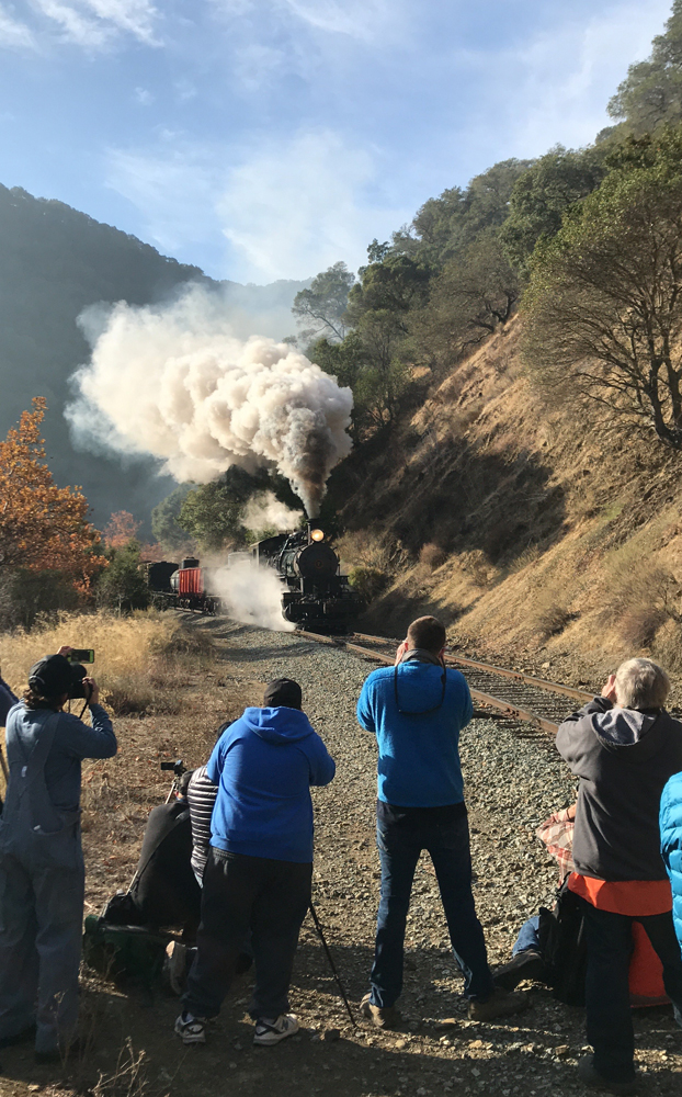 People taking pictures of steam engine