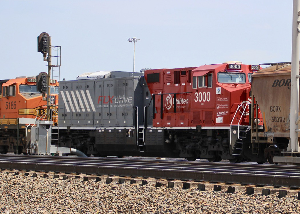 Red and gray battery-electric locomotive