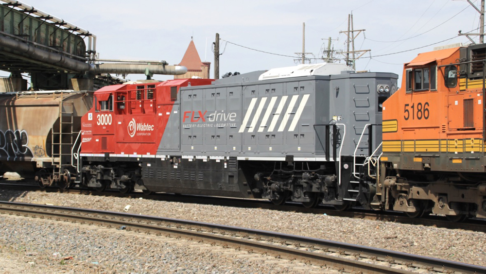 Rear view of red and gray battery-electric locomotive