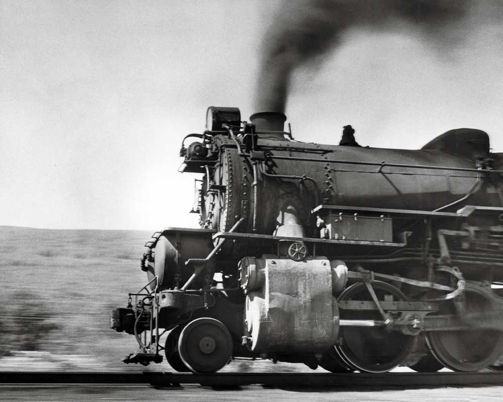 Steam locomotive front in profile at speed