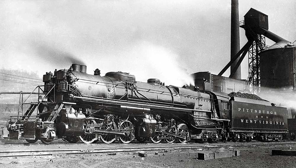 Steam locomotive parked by serving facilities
