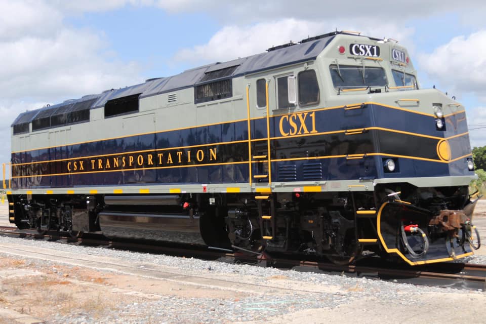 Diesel locomotive in fresh gray, blue, and black paint