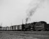 Steam locomotive switching freight cars.