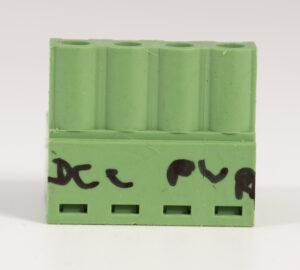 Green four-pin plug with left two terminals hand-lettered “DCC” and right two terminals labeled “PWR”