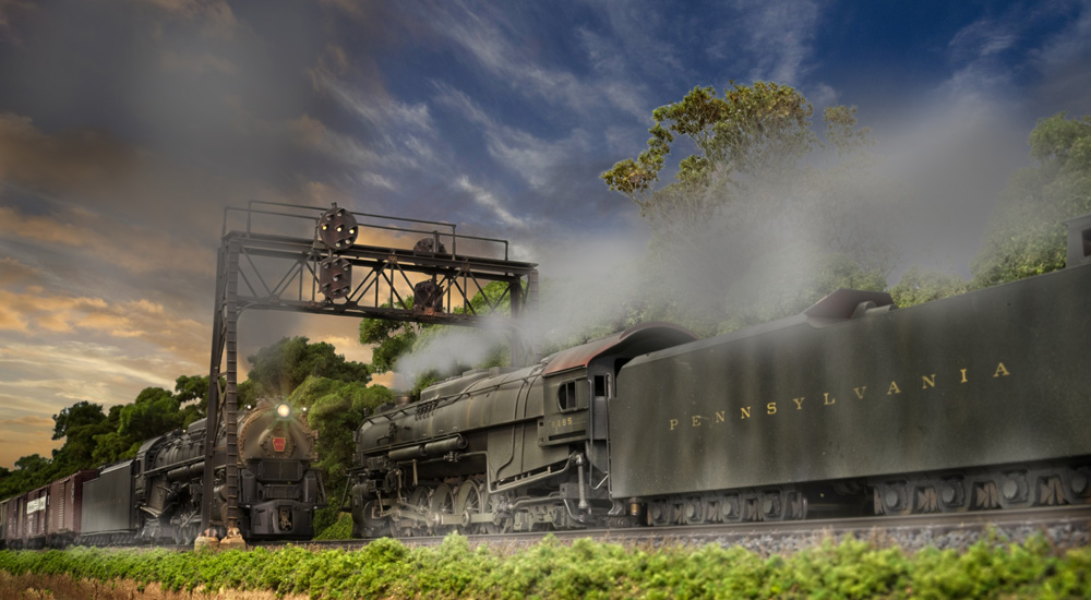 Two Pennsylvania RR steam locomotives meet under a twilight sky, a cloud of smoke, and a signal bridge