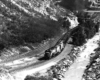 Diesel locomotives with coal train along river in canyon