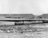 Five diesel locomotives on a hopper train in a sweeping S curve