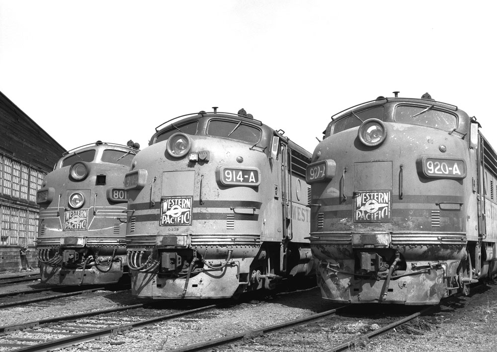 Black and white photo of three F unit locomotives in Stockton roundhouse 