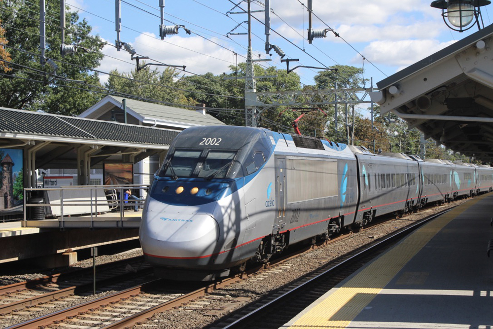 Silver high speed train passes through station