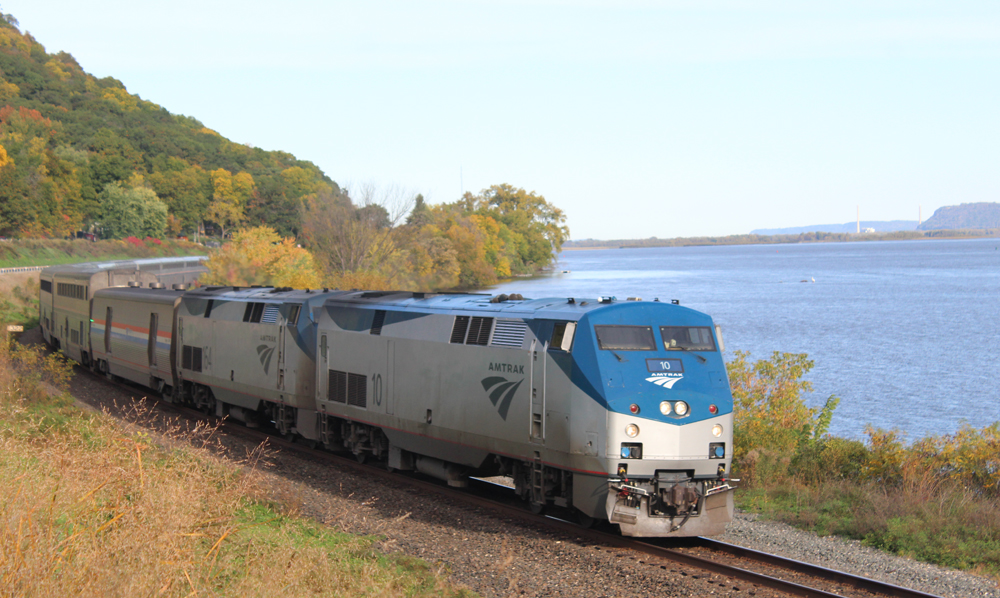 Passenger train on tracks along river