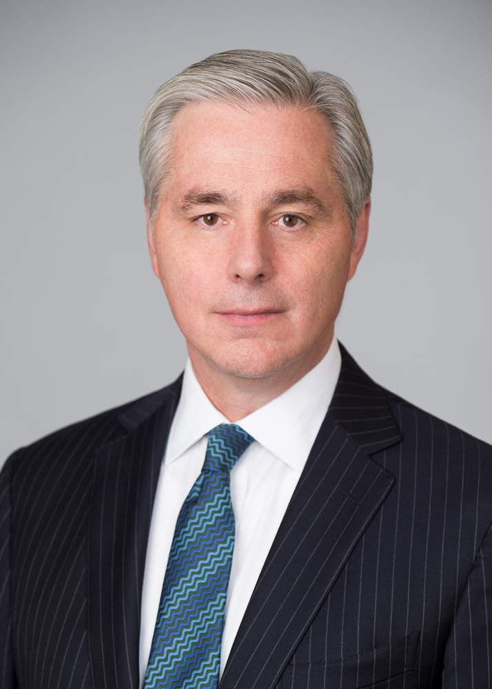 Head shot of gray-haired man in suit