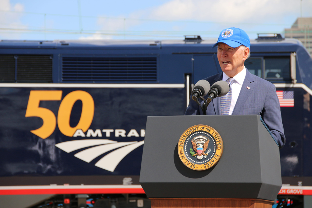 President Biden speaking in front of locomotive