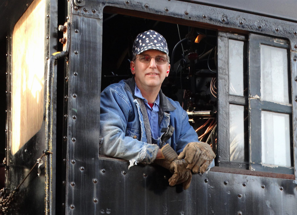 Man in cab of steam locomotiveC