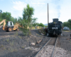 Tractor loads coal into steam locomotive