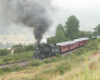 Steam train on hillside.