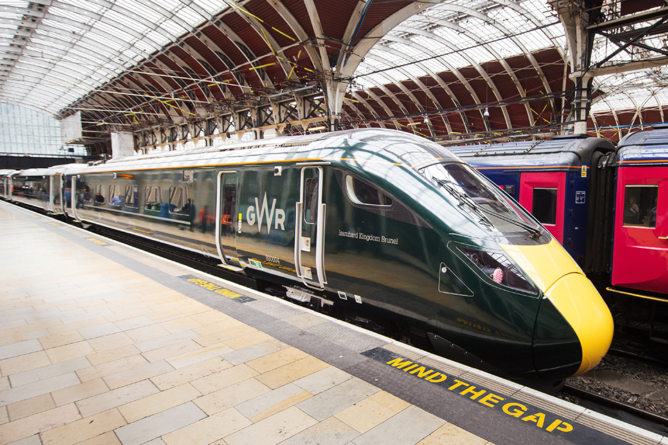 Black high speed train with yellow trim in station