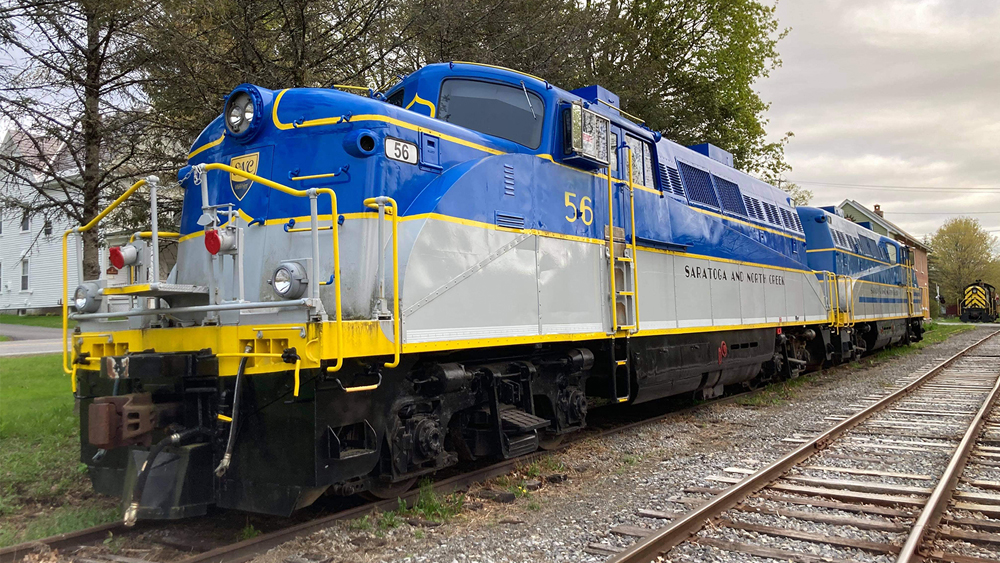 Blue, gray, and yellow semi-streamlined diesels