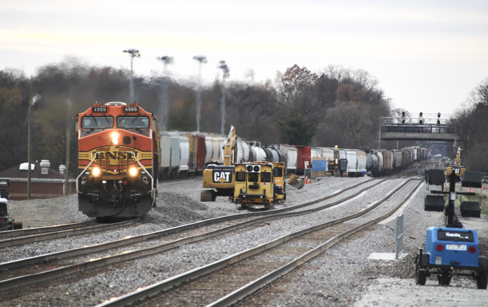 Freight train on shoofly curves with two straight tracks in foreground