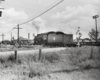 A freight locomotive passing by a field