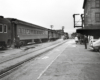 A trains sits as a conductor stands by the open door