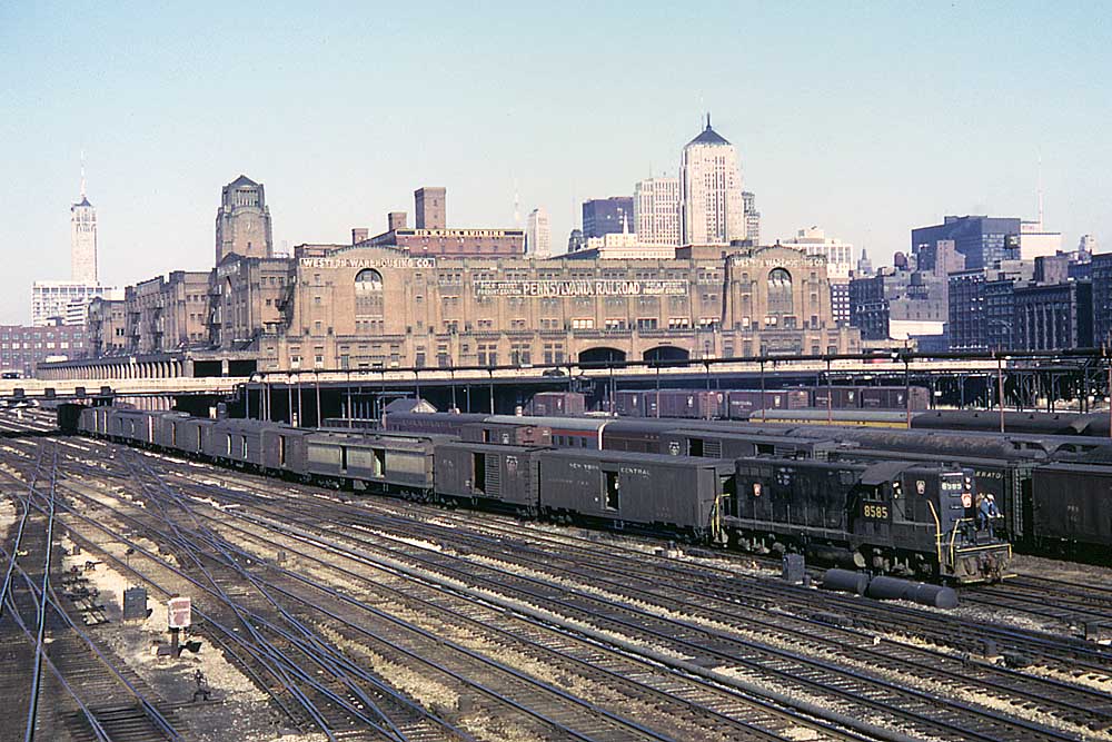 Rail yard with cars in front of large brick structure
