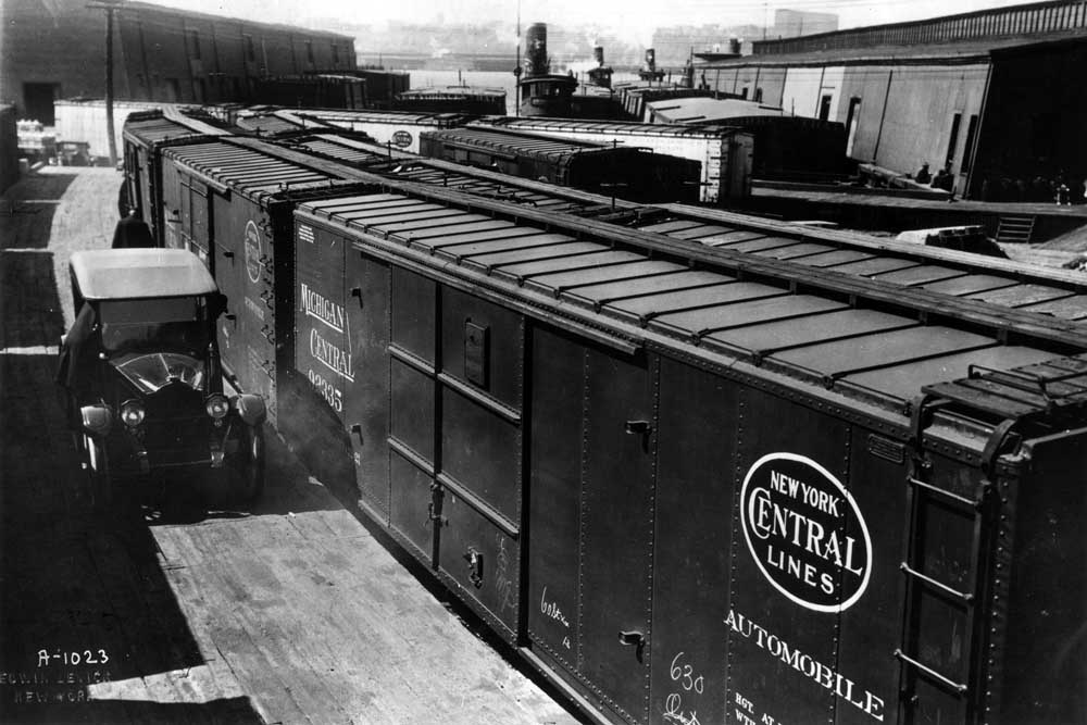 Boxcars lined up for loading along curved platform