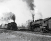 Steam locomotives on two freight trains meeting