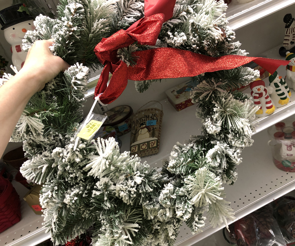 hand holding a Christmas wreath