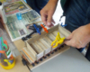 A club member clamps his flatcar project while the glue dries