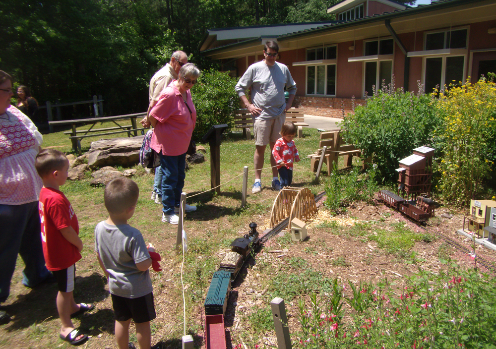 A family watches a large-scale train display