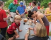 People at a table, building wooden trains