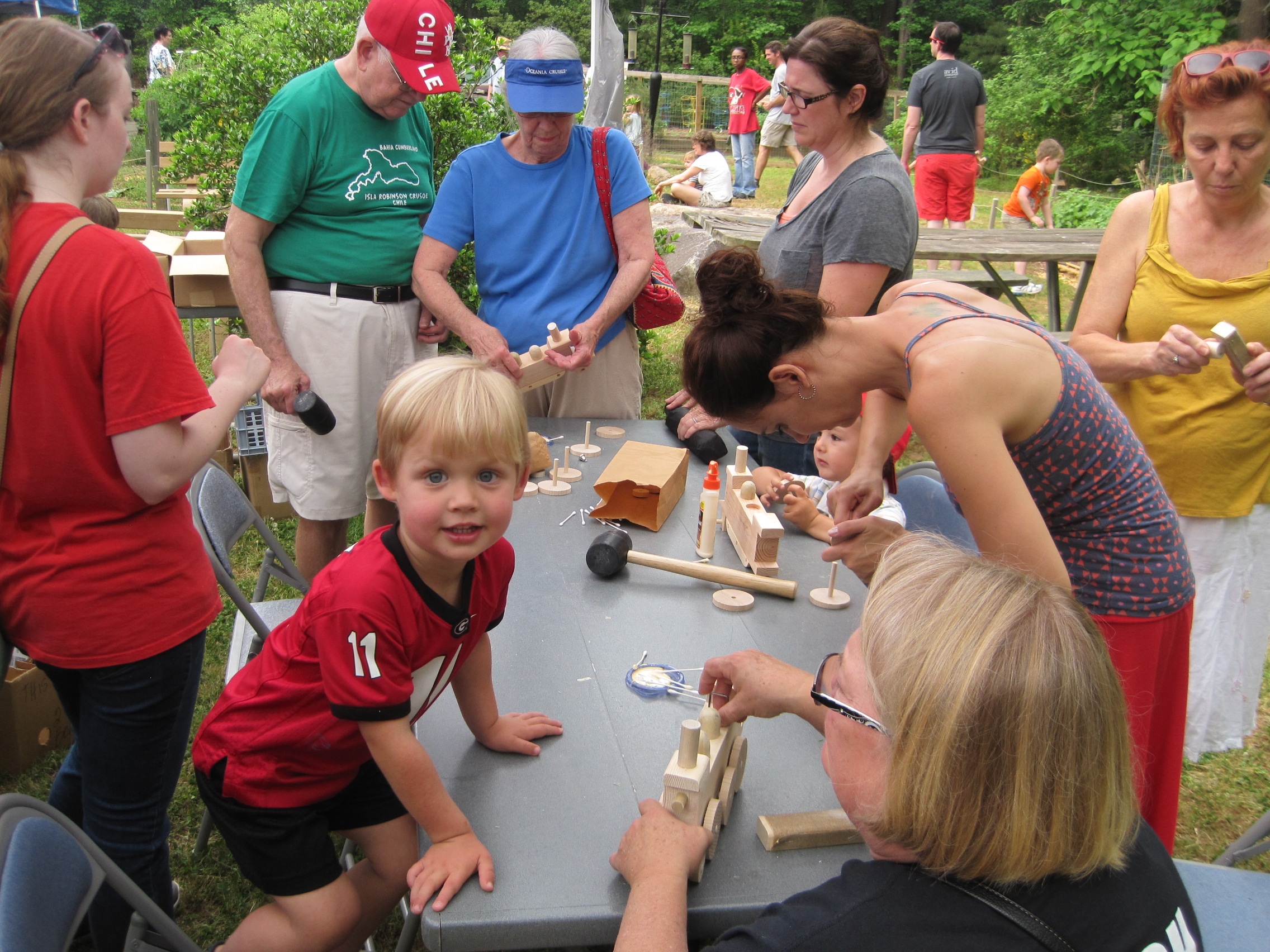 People at a table, building wooden trains