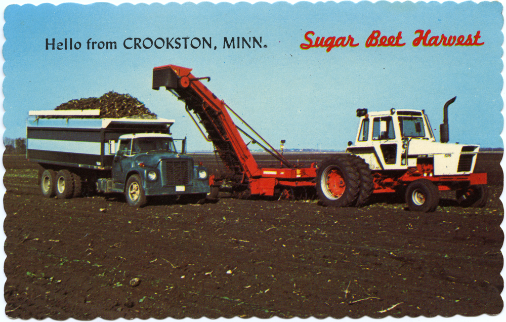 Photo of farm field with tractor, beet lifter, and beet truck.