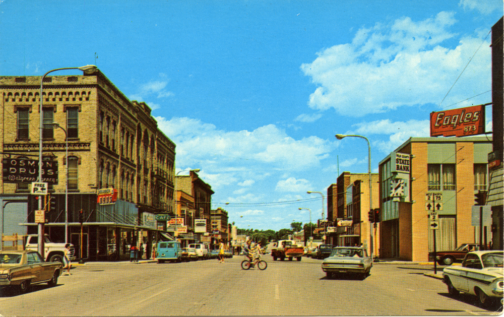 Image of downtown scene with buildings and vehicles