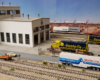 Blue-and-yellow Santa Fe diesel locomotives are serviced at a yard outside a BNSF engine shop