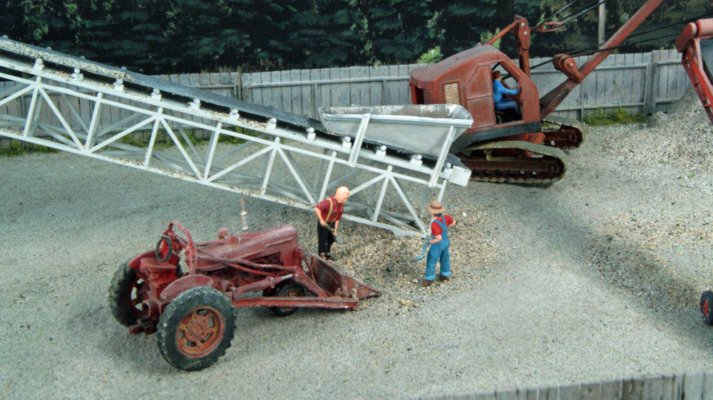 Model figures next to grain elevator