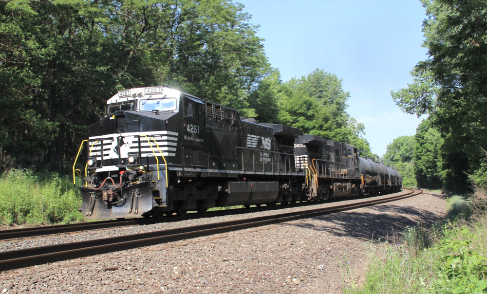 Black locomotives lead train through curve