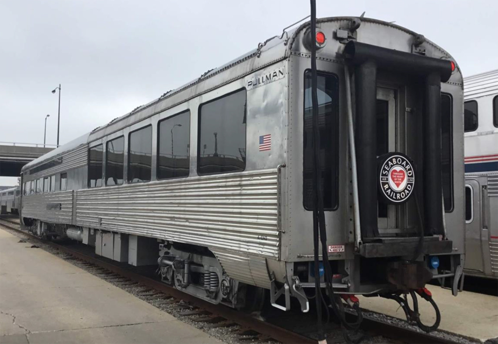 Stainless steel passenger car with end windows