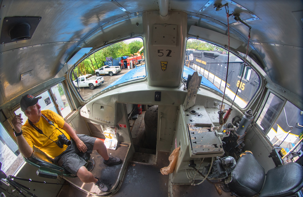 Man sitting in cab of locomotive