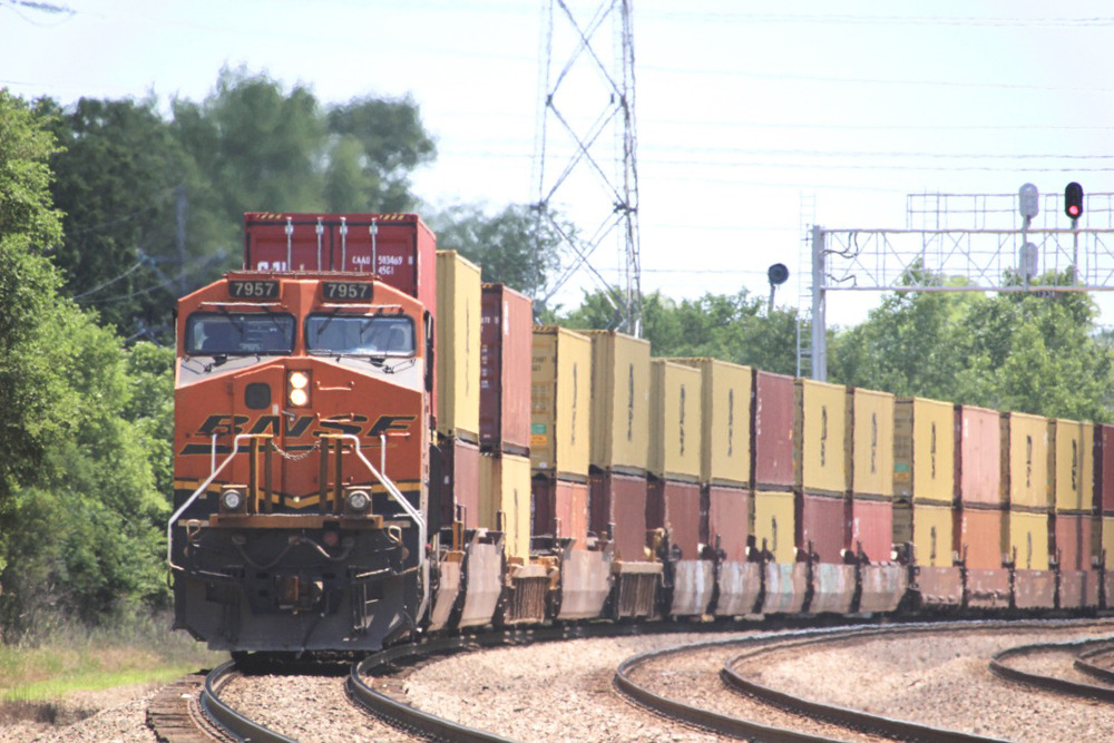 Locomotive and train of orange and yellow containers