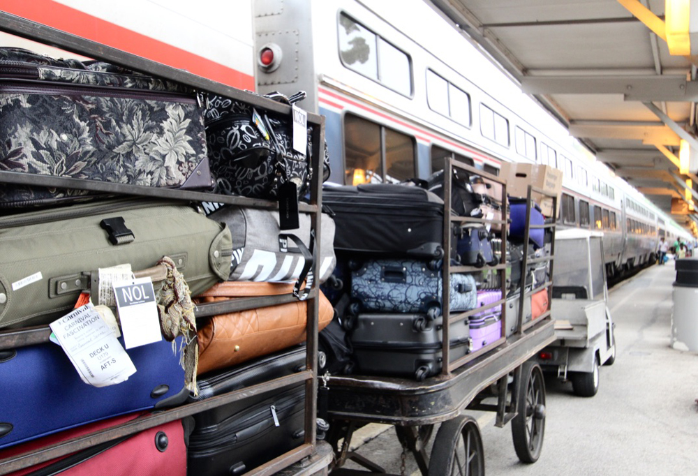 Baggage wagons packed with luggage next to train