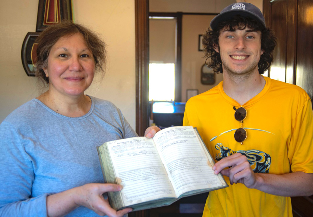 Woman and young man holding book