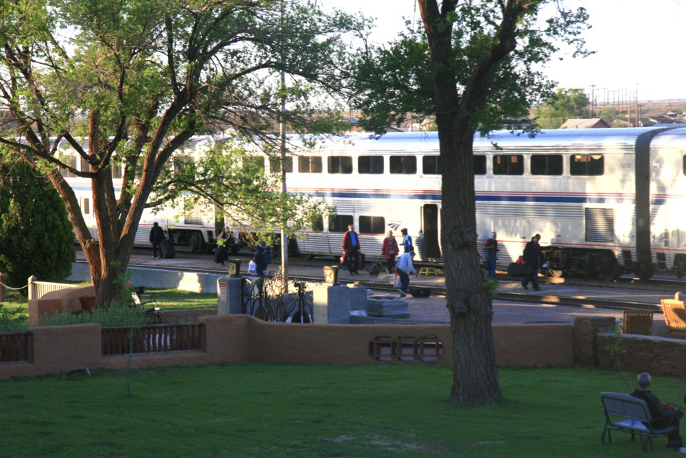 Bilevel passenter cars viewed across grounds of hotel