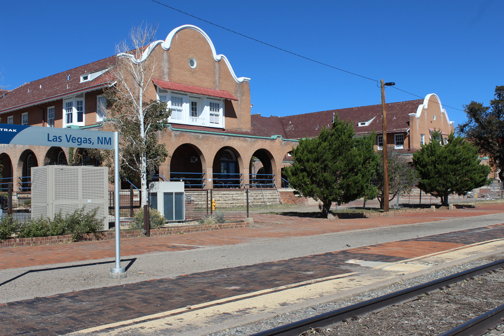 Spanish-style hotel building next to station platform