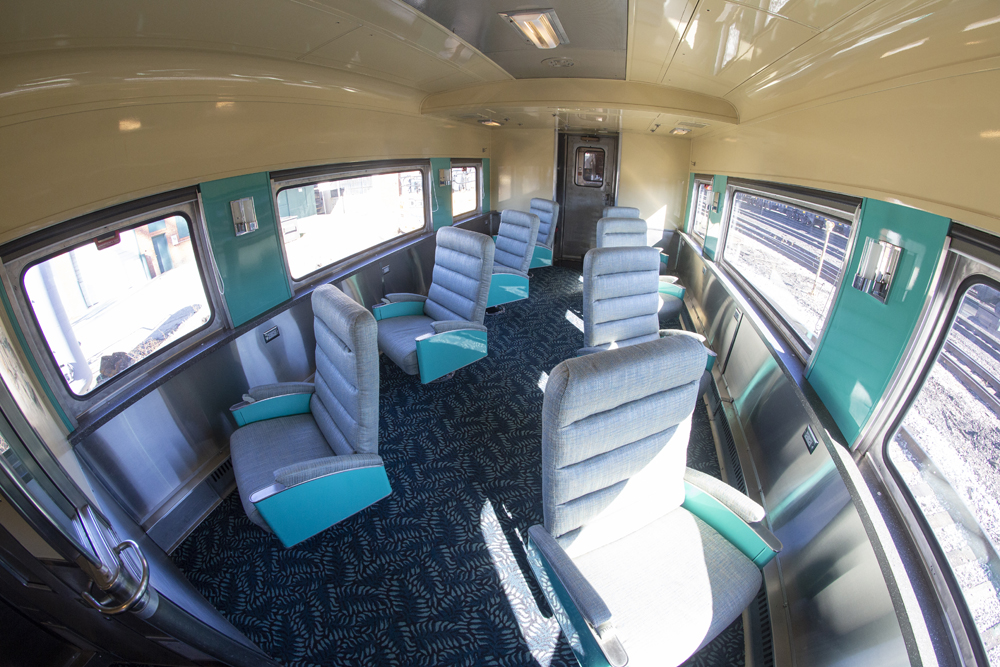 View of unoccupied lounge seats in an upscale passenger car.