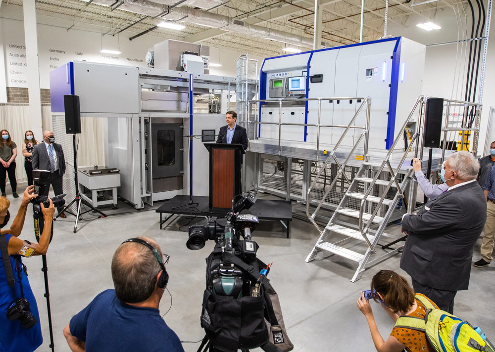 Media event with people around 3D printing device